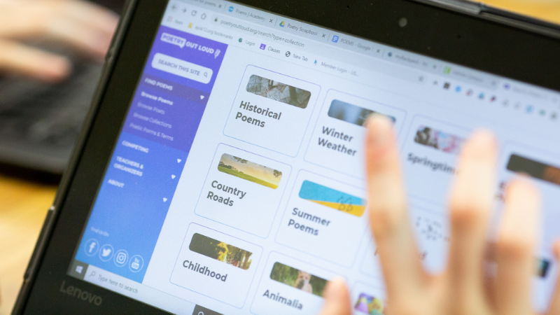 Photo of a student's hand using a Chromebook for learning Photo of a student's hand using a Chromebook for learning
