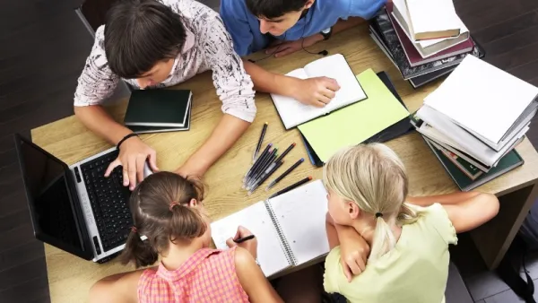 Kids working together around a table at school
