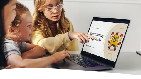 Photo of two students learning about digital citizenship concepts in a classroom.